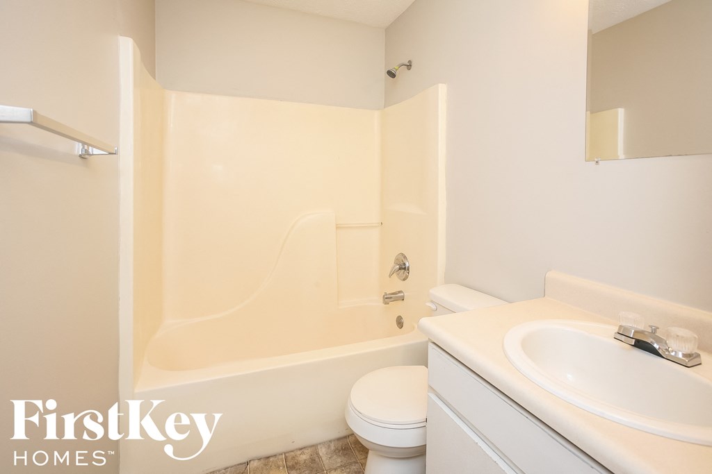 a bathroom with a sink toilet and a tub