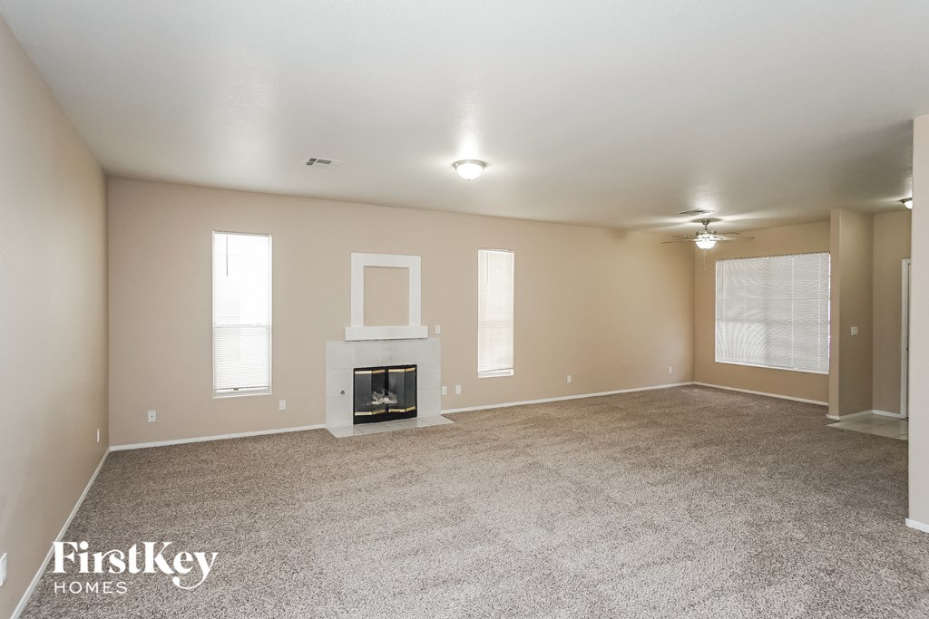 the living room of an empty house with a fireplace