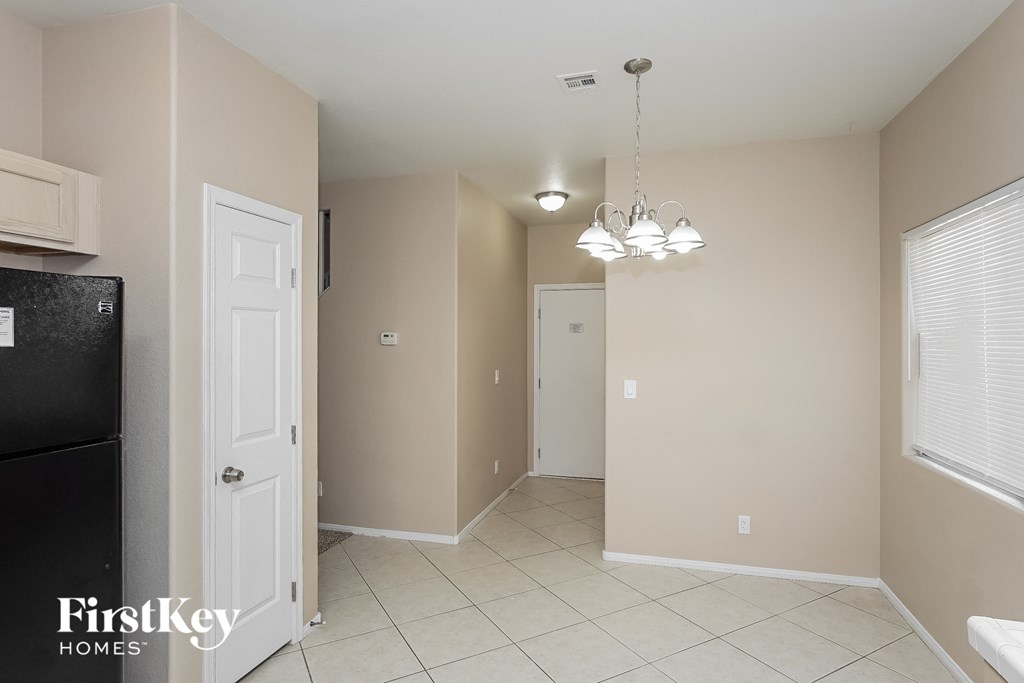 a kitchen and dining room with a door to the hallway