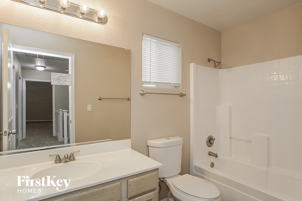 a bathroom with a sink and a toilet and a shower