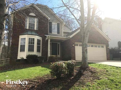 a brick house with a white garage door