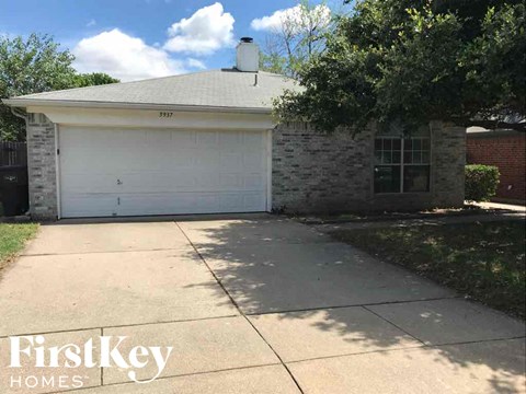 a driveway in front of a house with a white garage door
