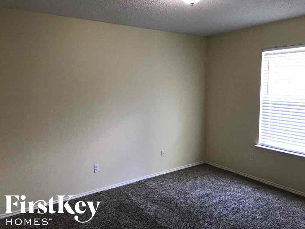 an empty room with white walls and a window