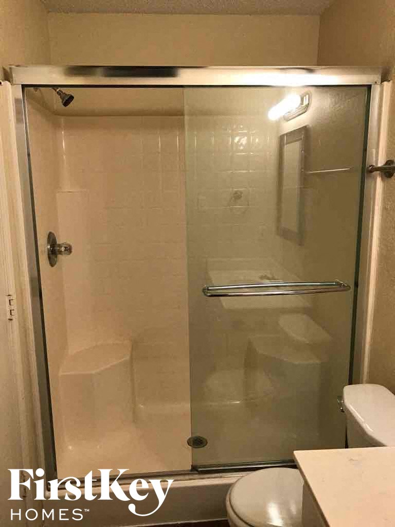 a bathroom with a shower and a toilet