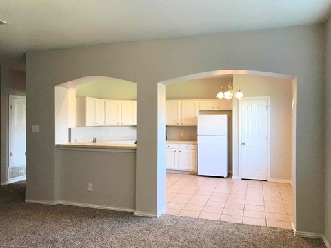 A kitchen with white appliances and cabinets is shown.