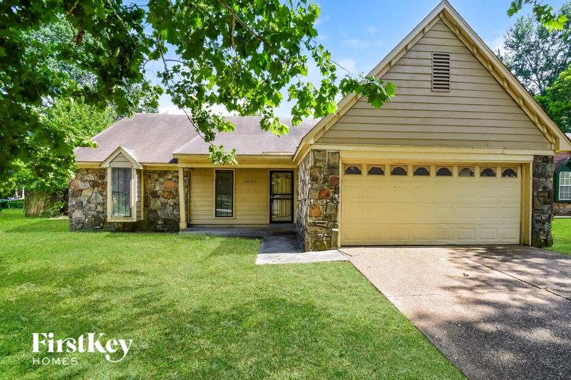 A house with a garage and a driveway is shown.