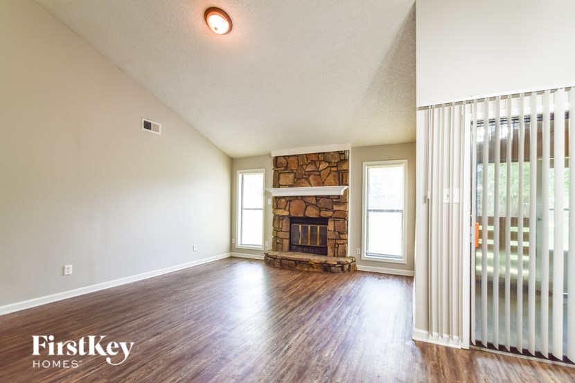 A room with a fireplace and a window.