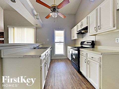 A kitchen with a FirstKey Homes logo.