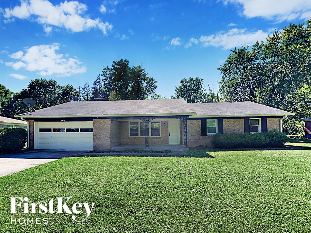 A house with a lawn in front of it.