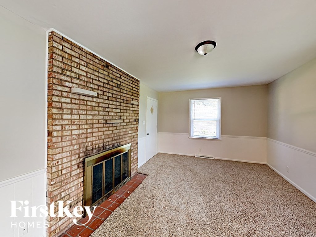 A room with a brick wall and a window.