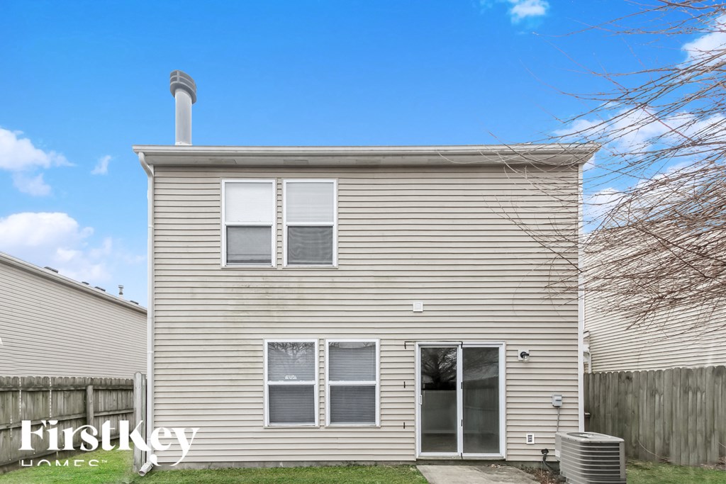 A house with a grey facade and a chimney on the roof.