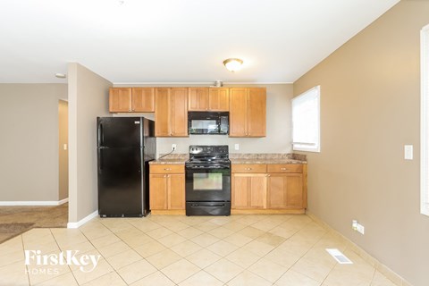 a kitchen with black appliances and wooden cabinets