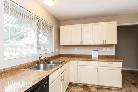A kitchen with a sink and cabinets.