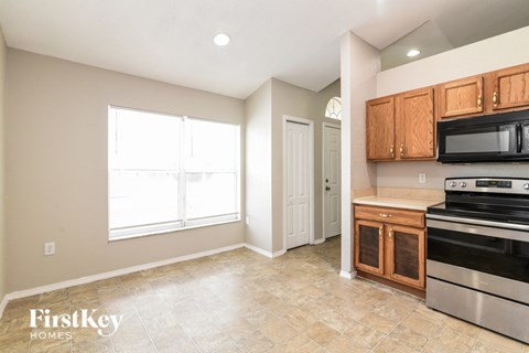 A kitchen with a stove top oven and microwave.