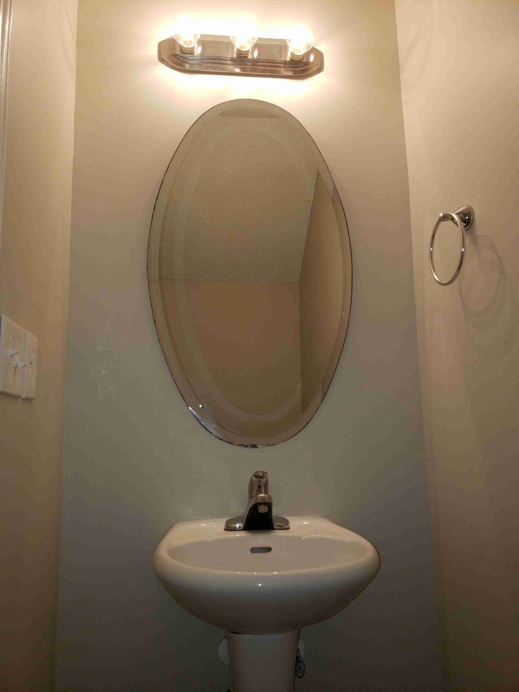 a small bathroom with a sink and a mirror