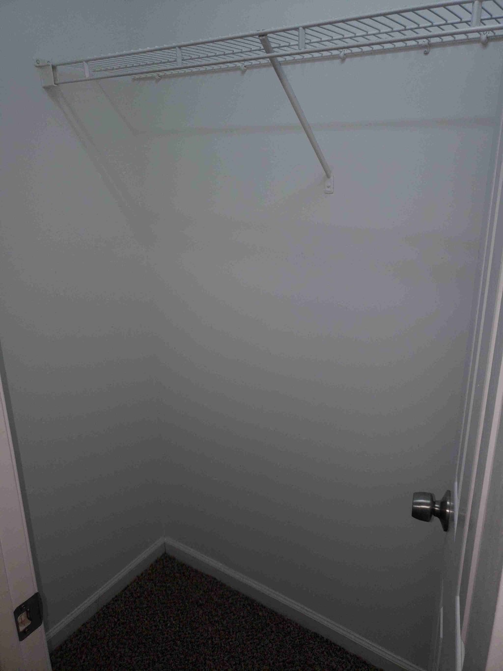 a small bathroom with a shower and a rack in it