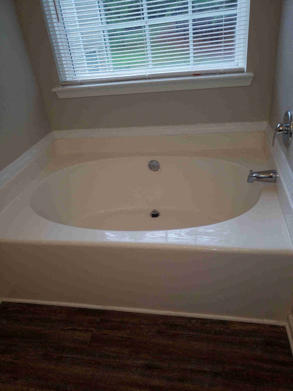 a bath tub in a bathroom with a window