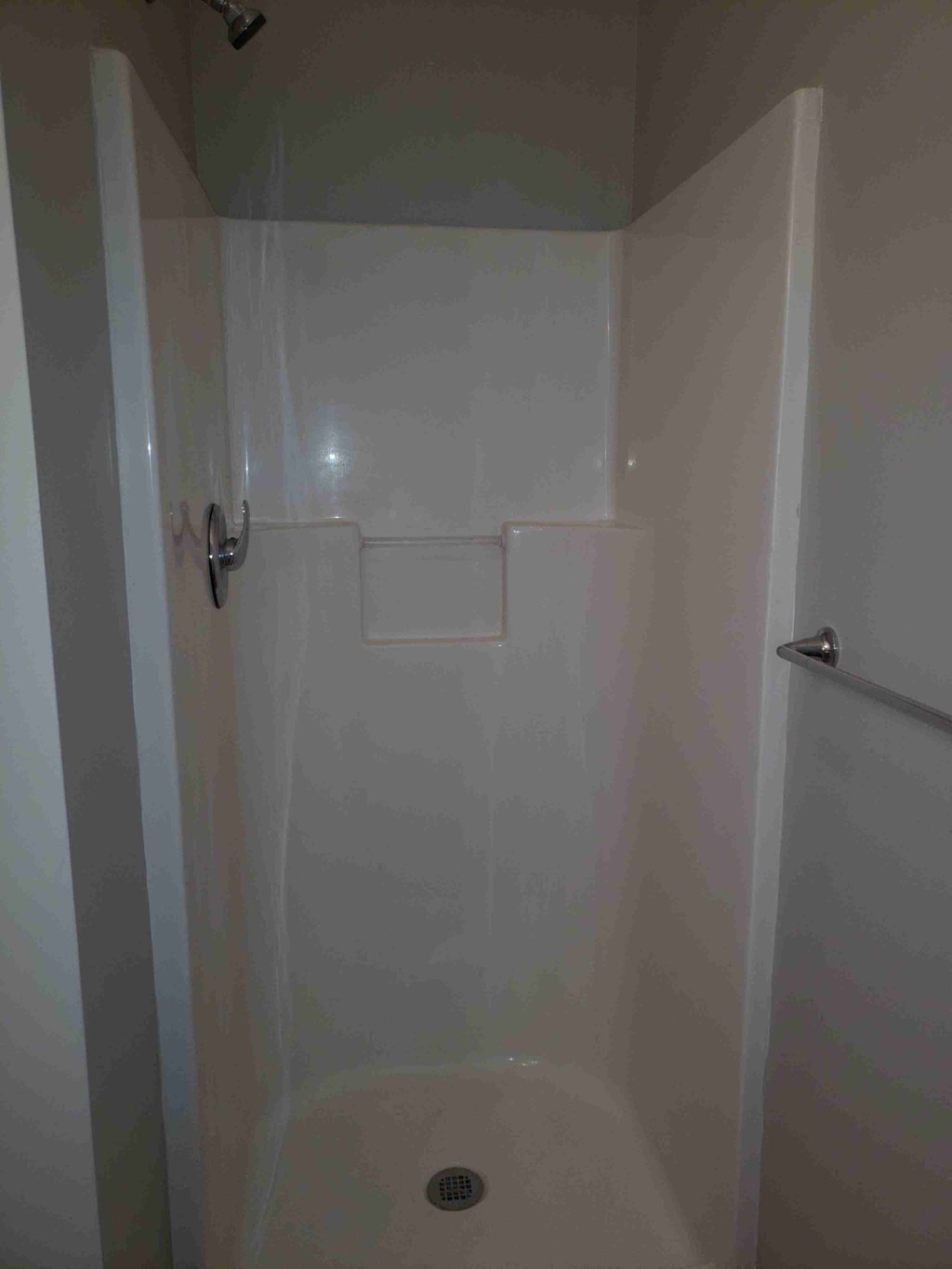 a shower in a bathroom with the door open