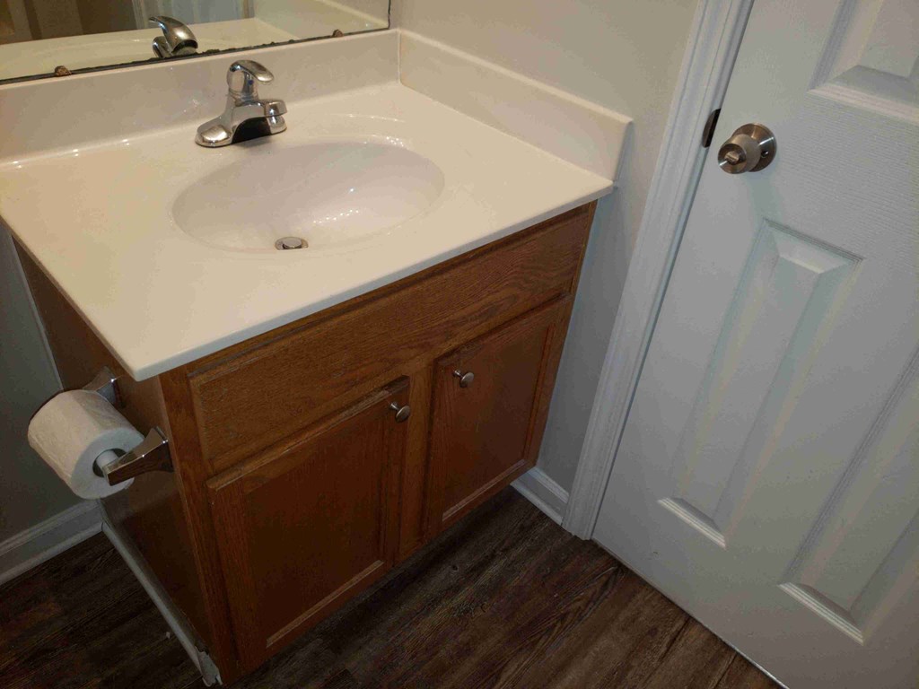 a small bathroom with a sink and a door