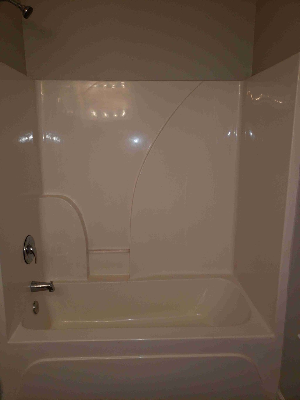 a white bathroom with a shower and a tub