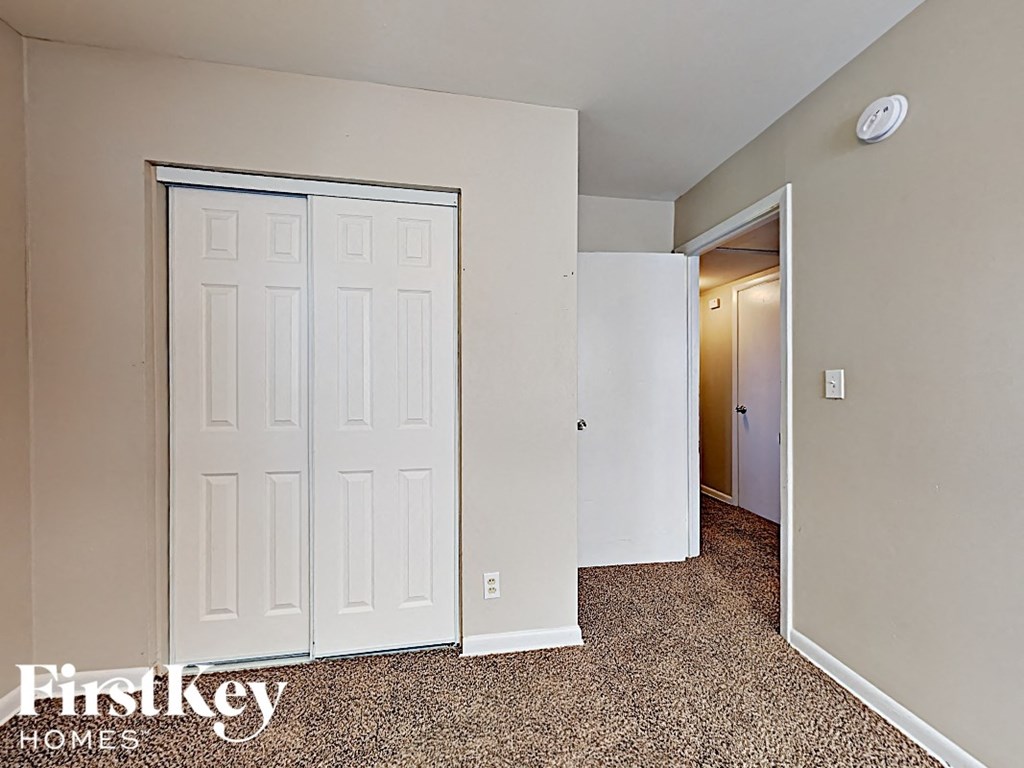 a bedroom with two closets and a door to a hallway