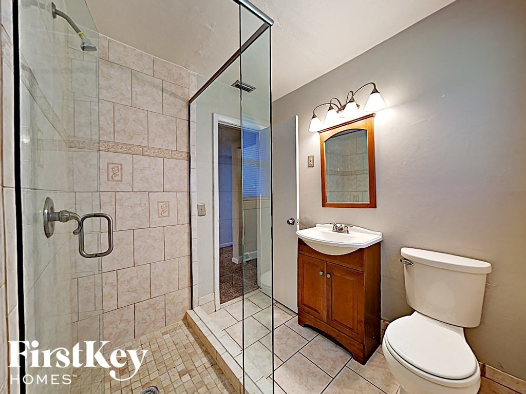 a bathroom with a toilet sink and a shower