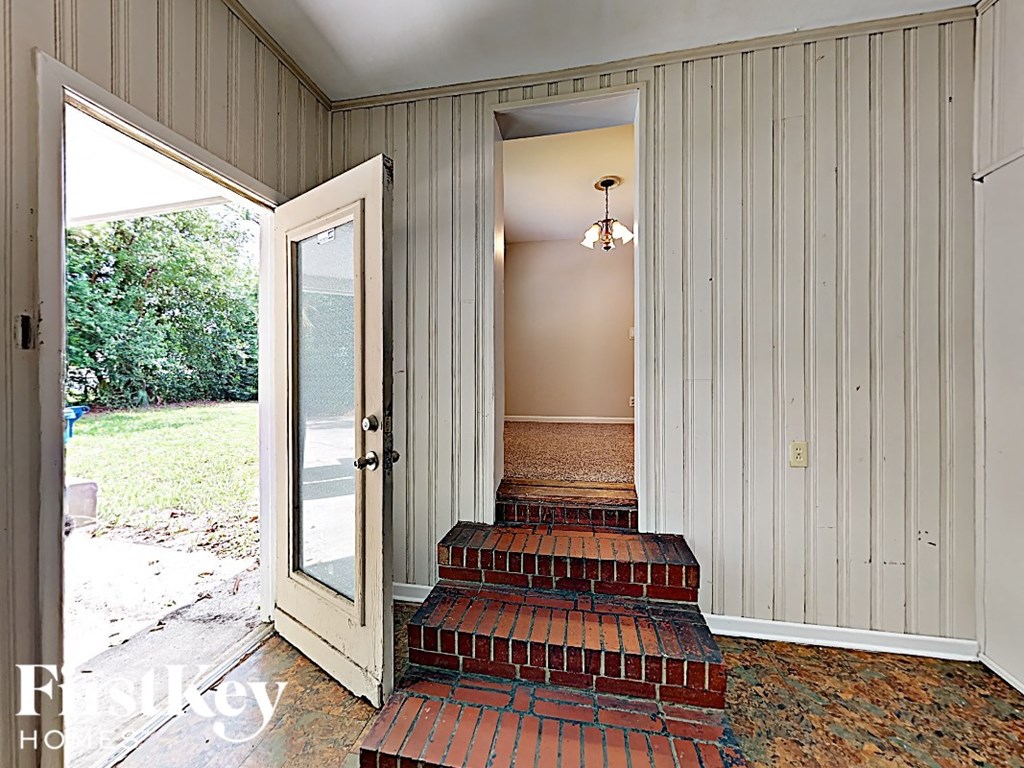 the front door is open to theoyer and the stairs to the house