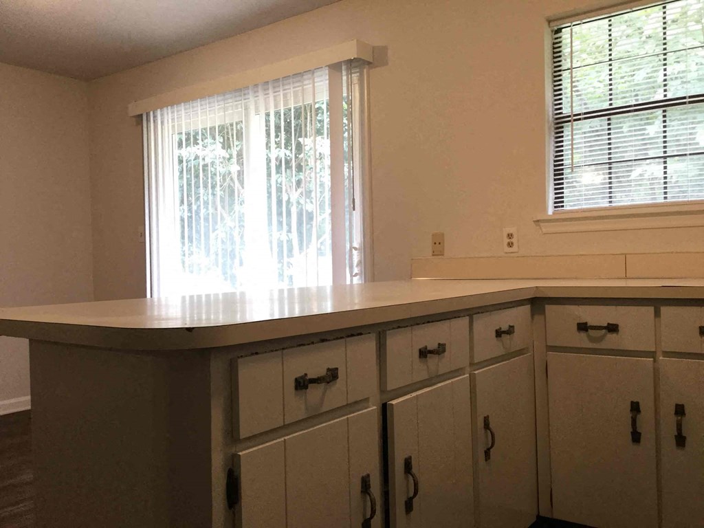 a kitchen with white cabinets and a counter top