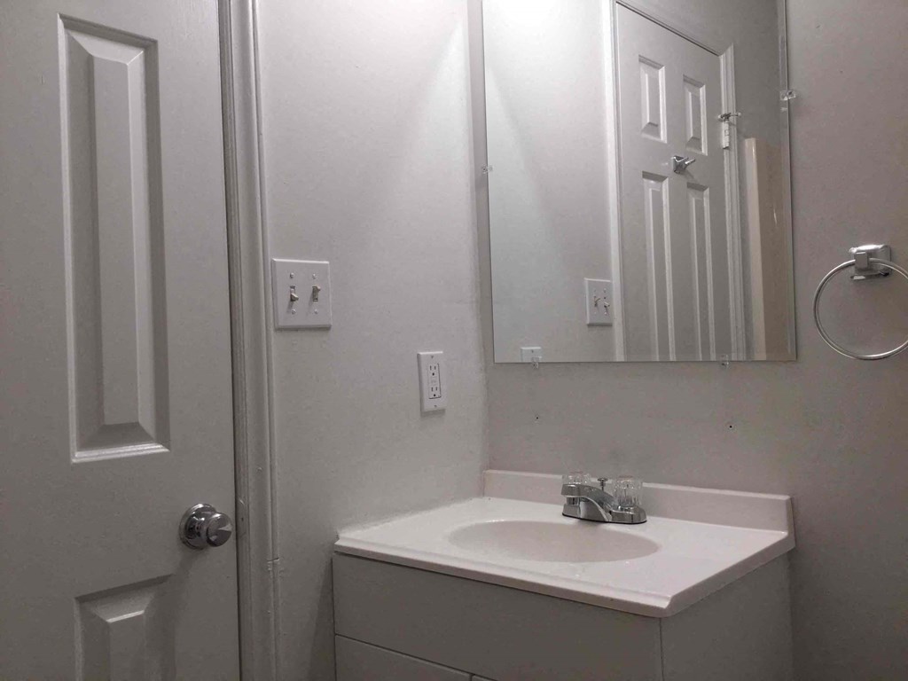a small bathroom with a sink and a mirror
