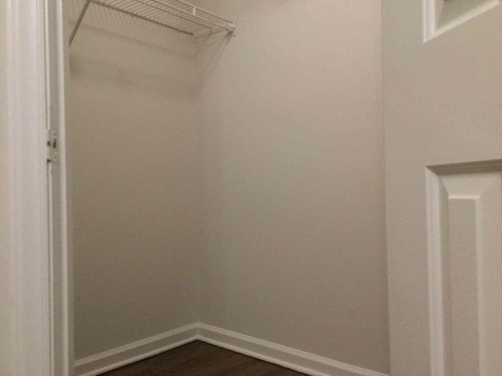 a small closet in a room with white walls and a door