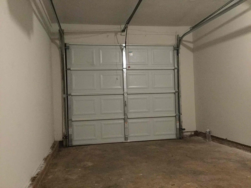 a garage door in a room with a cement floor