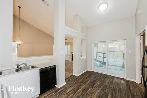 A kitchen area with a sink and a window.