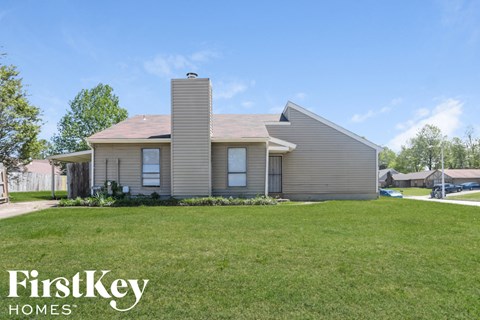 a small house with a lawn in front of it