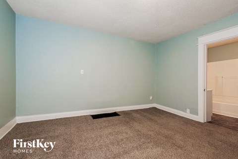 the living room of a home with blue walls and carpet