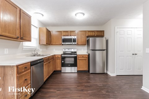 A kitchen with wooden cabinets and stainless steel appliances.