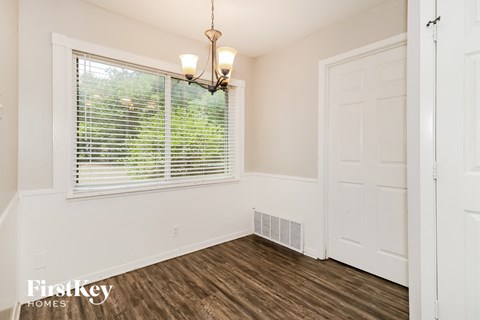a bedroom with a large window and a white door