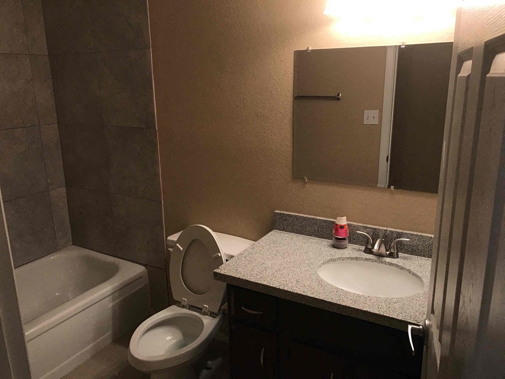 a small bathroom with a sink toilet and bath tub