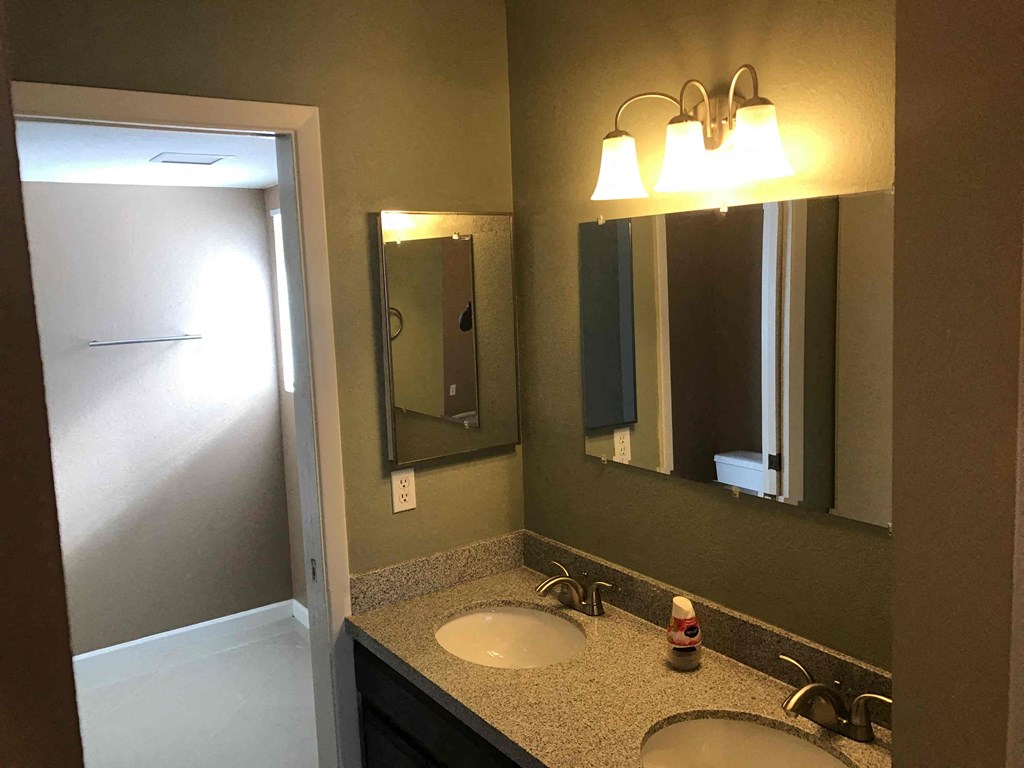 a bathroom with two sinks and a mirror