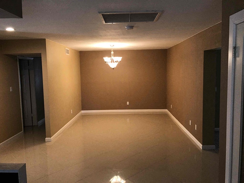 a empty empty room with a chandelier in the ceiling