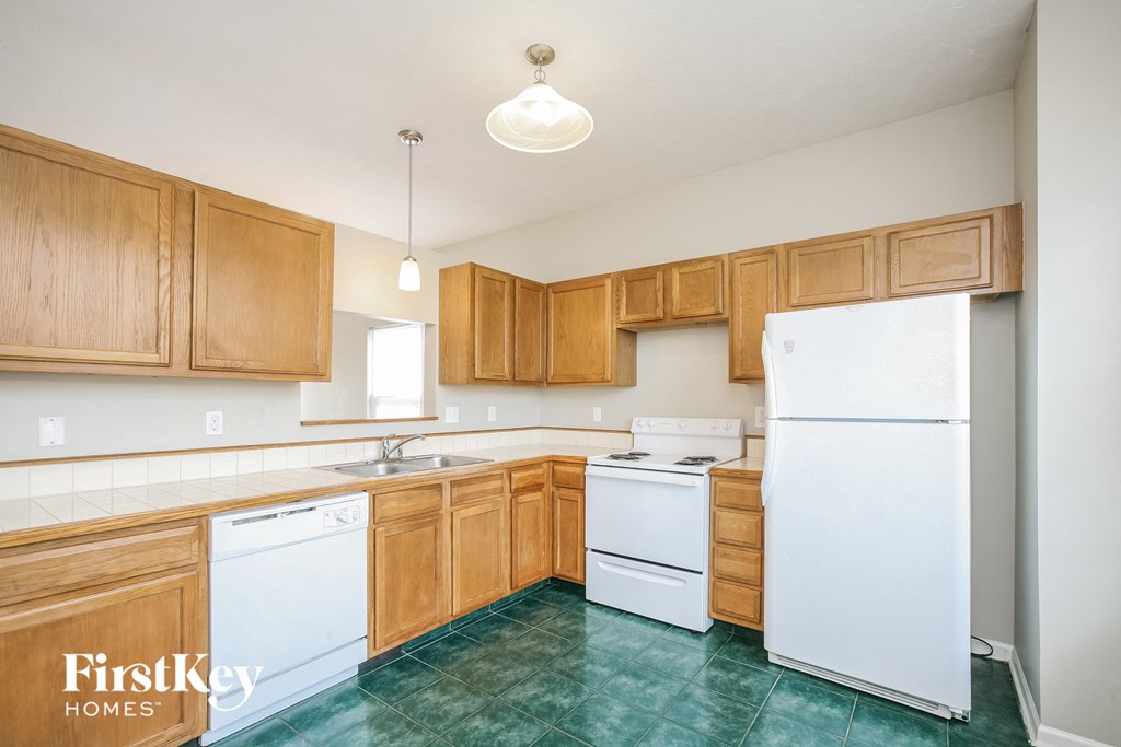 a kitchen with white appliances and wood cabinets