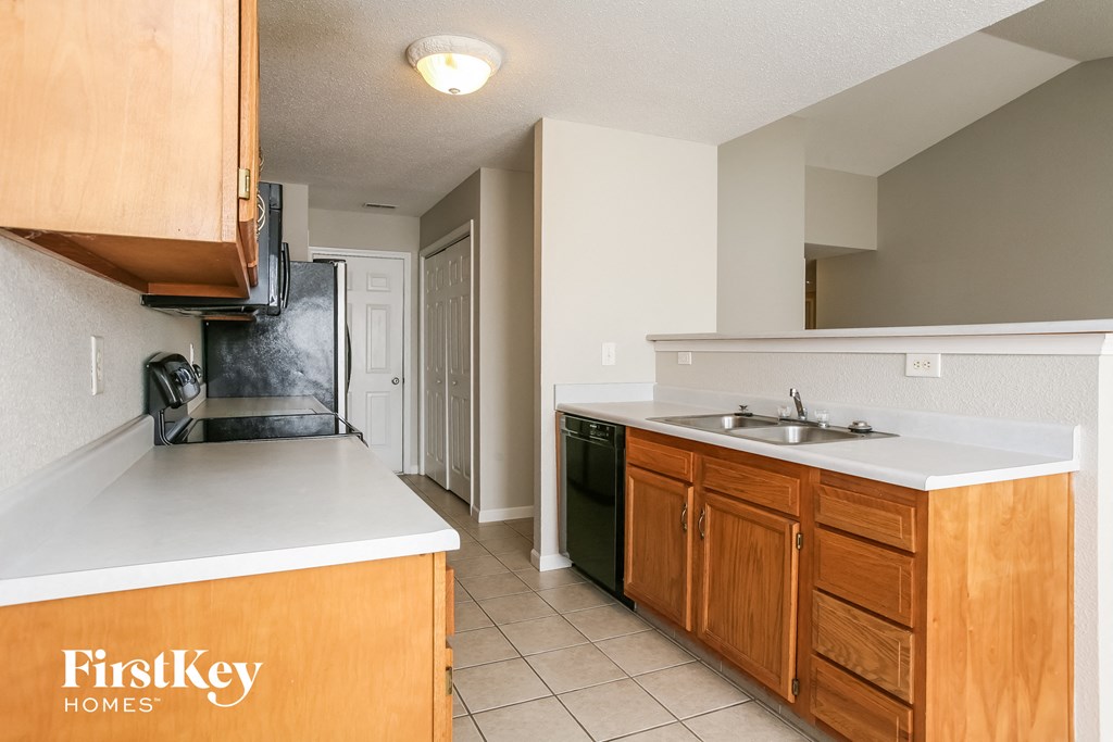 A kitchen with wooden cabinets and a white countertop.