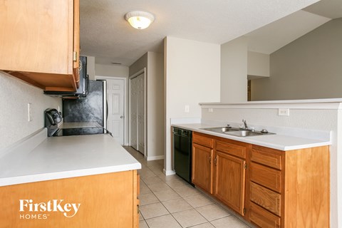 A kitchen with wooden cabinets and a white countertop.