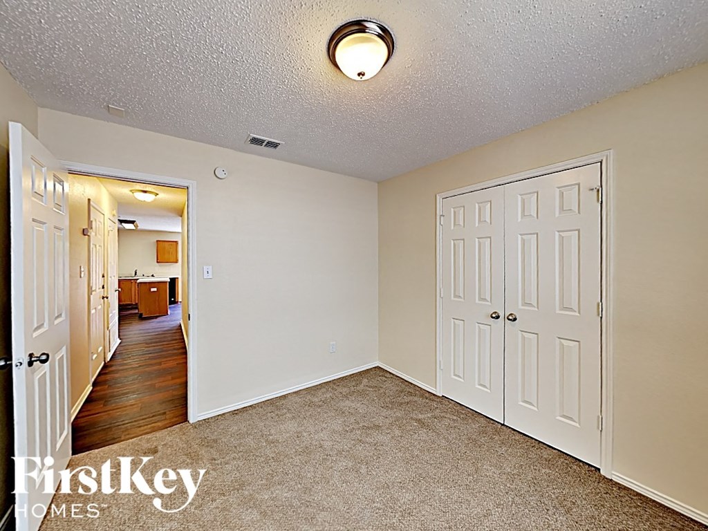 a bedroom with two closets and a door to a hallway