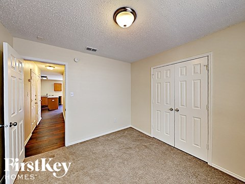 a bedroom with two closets and a door to a hallway