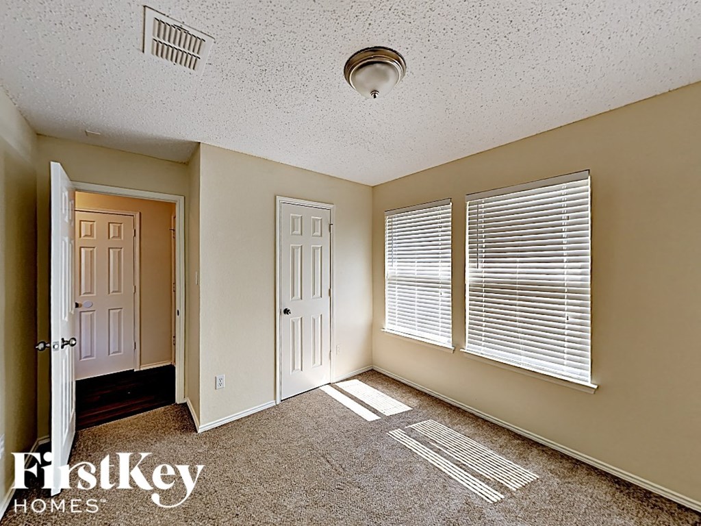 the second bedroom has a door to the hallway and a window