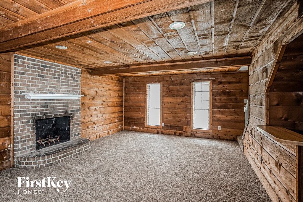 a brick fireplace in a room with wooden walls and floors