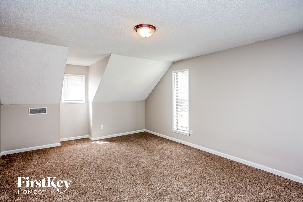 a bedroom with a carpeted floor and white walls