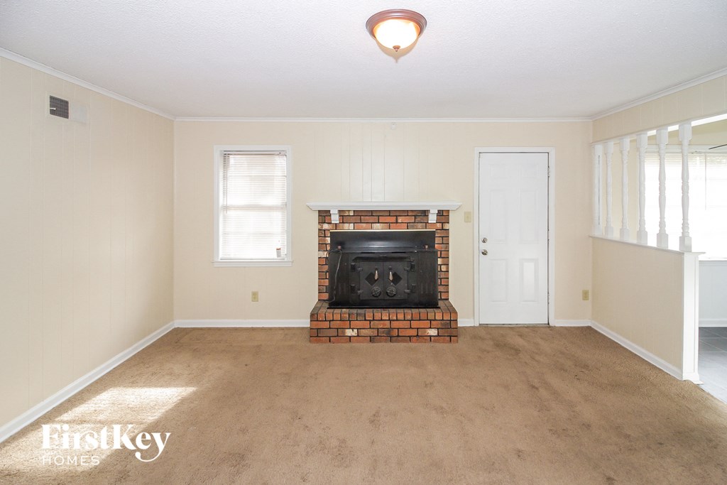 A room with a fireplace and a door.