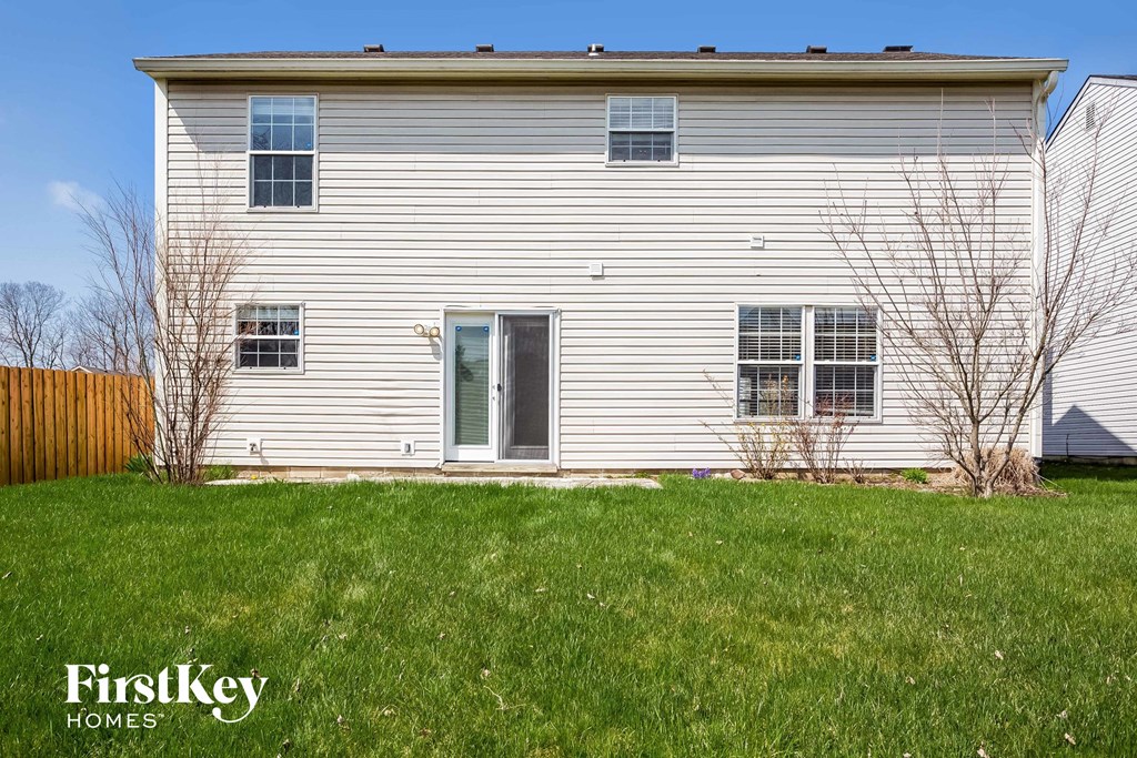 a white house with a green front yard