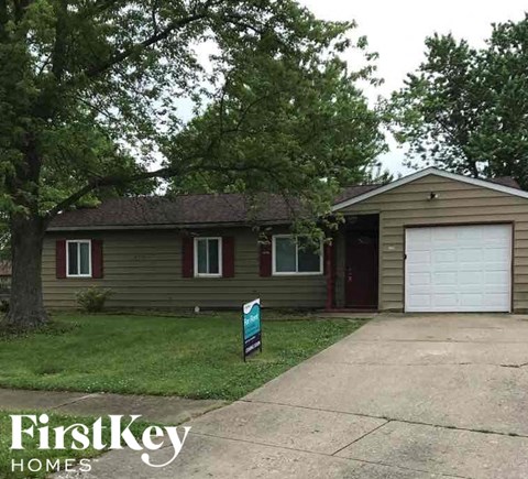 A house with a sign that says FirstKey Homes in front of it.